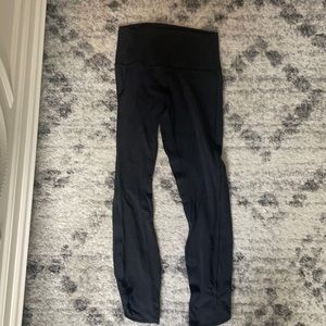 black lululemon leggings with mesh on the sides of the bottoms